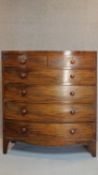 A Georgian mahogany bowfront chest of two short over four long graduating drawers on splay bracket