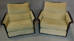 A pair of stained beech framed armchairs. H.80cm