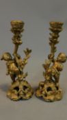 A pair of rococo style gilt candelabra, vinery supported by cherubs. H.27cm