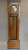 A continental Art Deco longcase clock in oak and burr walnut case with patent label to case. H.204cm