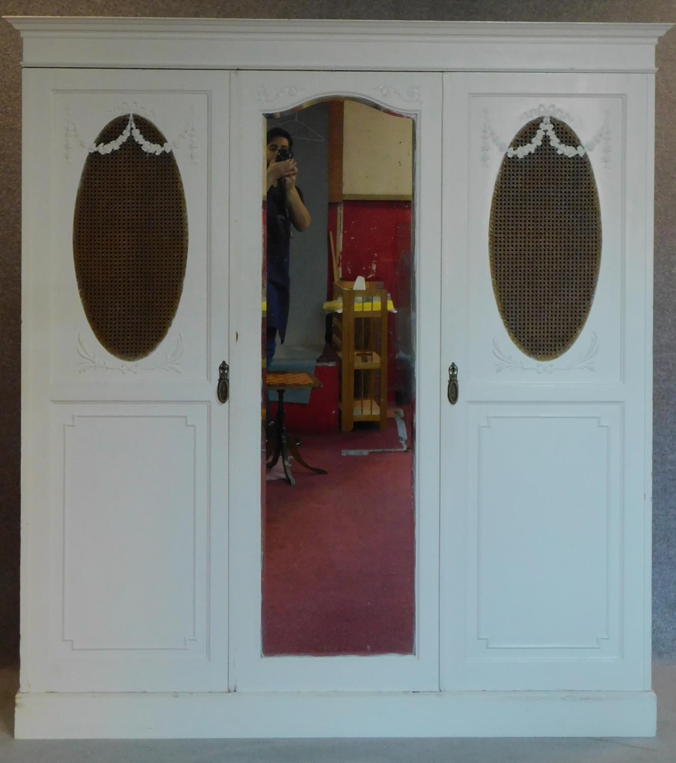 A mid 20th century white painted oak wardrobe with a fitted interior, slides and drawers and hanging