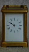 A brass cased carriage clock with white enamel dial. (missing minute hand and one glass side