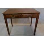 A mid 20th century oak writing table with tooled leather inset top and two frieze drawers. SH.76 W.