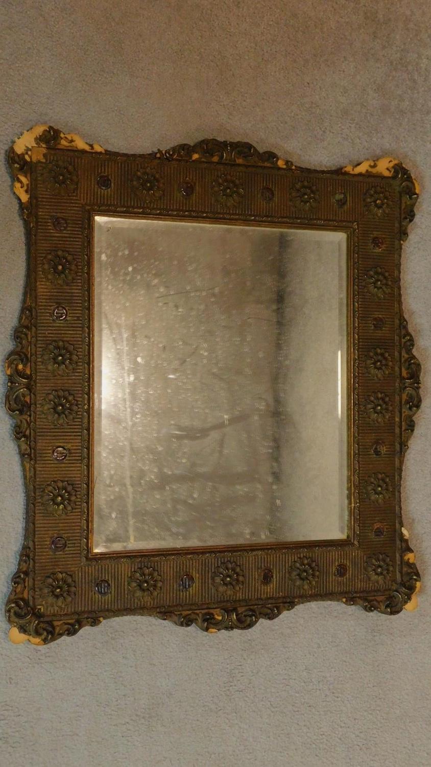 A 19th century gilt and gesso wall mirror with floral borders inset bevelled glass plate. 72x64cm