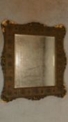 A 19th century gilt and gesso wall mirror with floral borders inset bevelled glass plate. 72x64cm