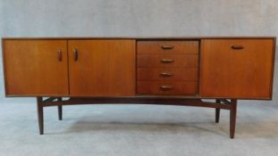 A mid 20th century teak G-Plan sideboard fitted cupboards and drawers. H.79 W.206 D.48cm