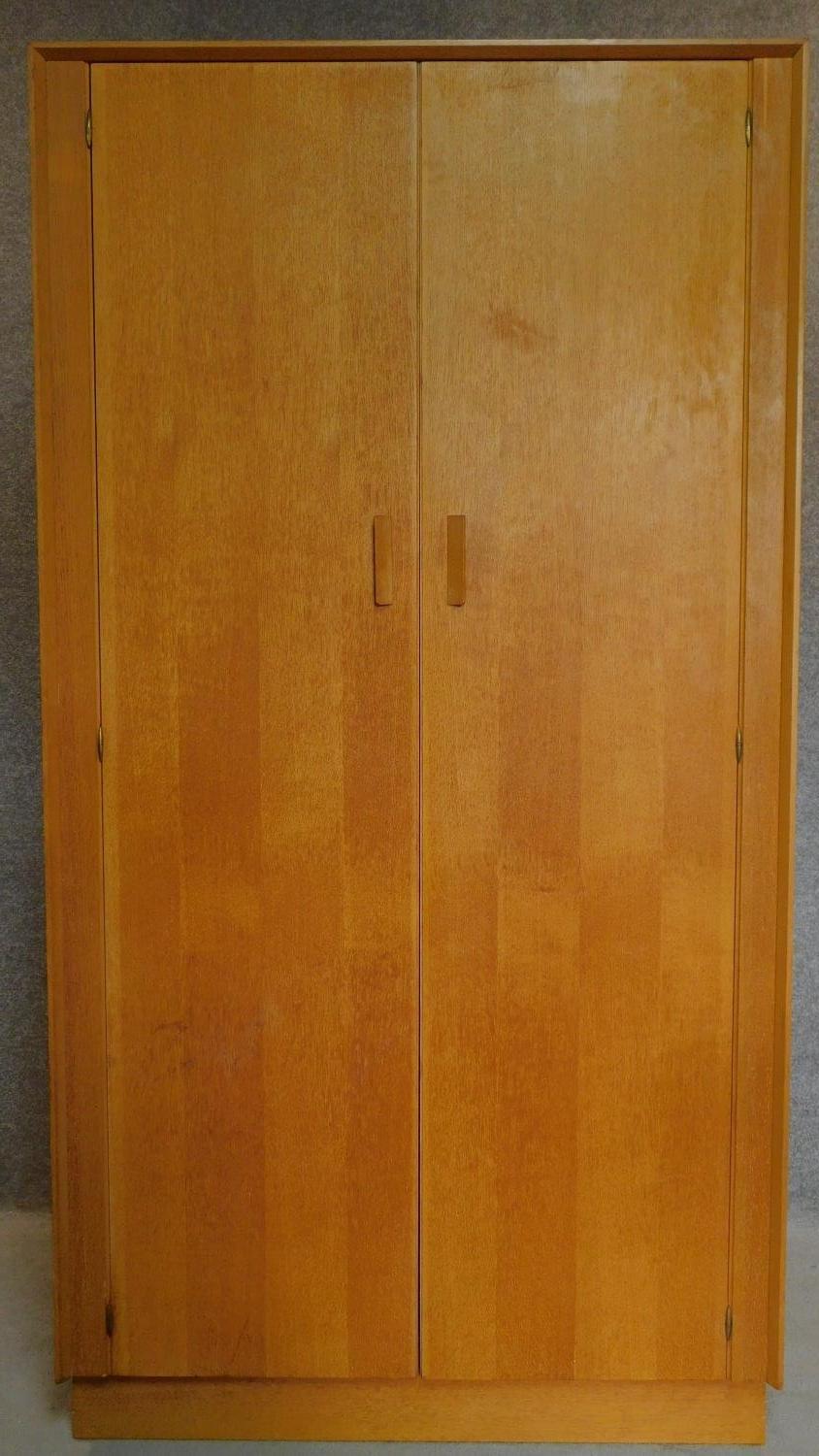 A fitted oak wardrobe by E. Gomme G-Plan, label to door. H.174 W.92 D.57cm