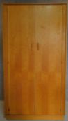 A fitted oak wardrobe by E. Gomme G-Plan, label to door. H.174 W.92 D.57cm