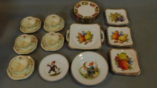 A collection of continental porcelain plates decorated with fruit and a set of vintage floral