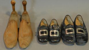 Two pairs of children's patent leather dress shoes and a pair of wooden lasts.