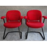 A pair of red upholstered Herman Miller armchairs on tubular metal cantilever bases. H.83