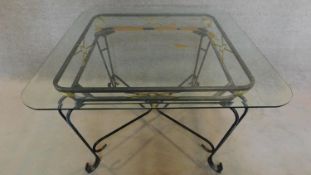 A wrought iron garden table with square bevelled glass top. H.73 W.115 D.115cm
