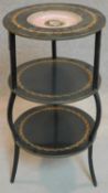 A 19th century brass and ebonised etagere with hand painted porcelain plate to top tier. H.80cm