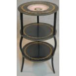 A 19th century brass and ebonised etagere with hand painted porcelain plate to top tier. H.80cm