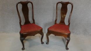 A pair of early Georgian style mahogany dining chairs with urn shaped splat, drop in seats on
