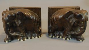 A pair of early 20th century carved teak bookends in the form of elephants. 14x27cm