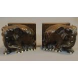 A pair of early 20th century carved teak bookends in the form of elephants. 14x27cm