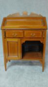 An Edwardian mahogany and inlaid bureau with fall front enclosing fitted interior above an