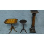 A Georgian style tilt top table with chess board inlay, another wine table and a torchere. H.91cm (
