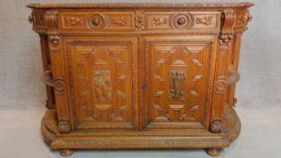 A 19th century Flemish style oak carved cabinet fitted doors and drawers. 100x155x44cm