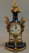 A blue ceramic and gilt metal French style mantel clock, white ceramic dial with laurel and caryatid