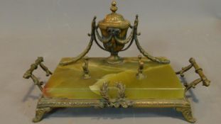 A 19th century French gilt metal and onyx desk stand. H.16 W.31 D.17cm