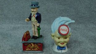 A painted metal Uncle Sam money box and another similar advertising Coca Cola. H.28cm