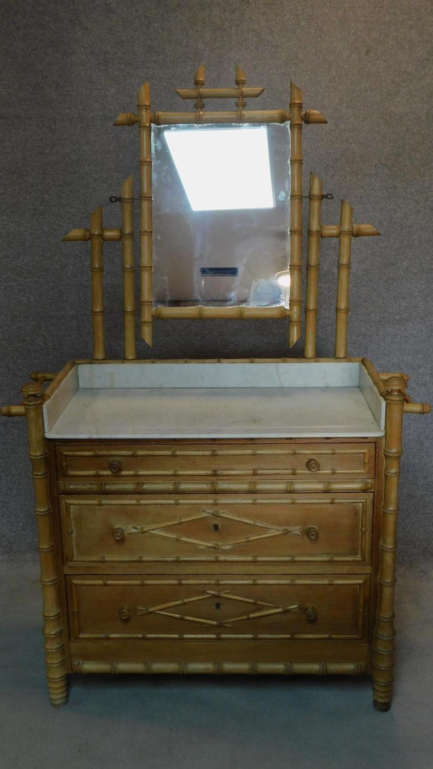 A Victorian pitch pine dressing table in the faux bamboo style with inset marble top. H.173 W.112