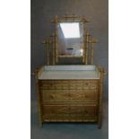 A Victorian pitch pine dressing table in the faux bamboo style with inset marble top. H.173 W.112