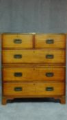 A mahogany military style brass bound two section campaign chest with green tooled leather inset