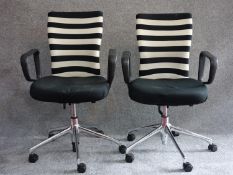 A pair of Vitra office swivel armchairs on chrome castered bases. H.100