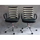 A pair of Vitra office swivel armchairs on chrome castered bases. H.100