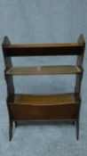 An Edwardian walnut book trough with brass carrying handles. H.79cm