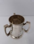 A three handled silver tyg/loving cup, Birmingham, 1919 by Martin Hall & Co Ltd. (119g).