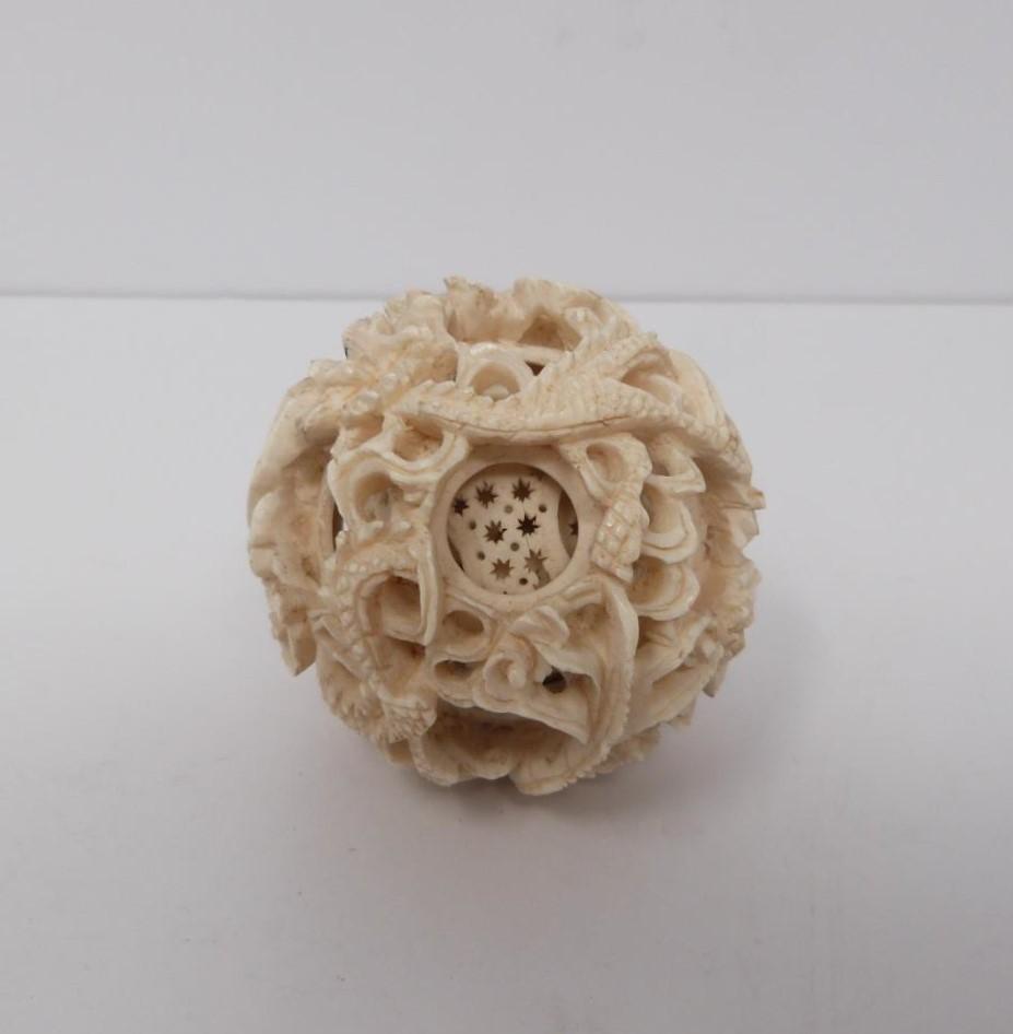 An early 20th century ivory puzzle ball and a small carved ivory and white metal burner, dragon - Image 5 of 7