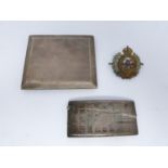 Two silver cigarette cases and a Royal engineer hat badge, one gilded inside, Birmingham, 1925,