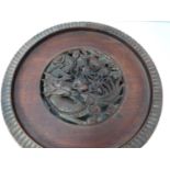 A Chinese 19th century hardwood pierced display stand, dragon motif with carved flower detailing