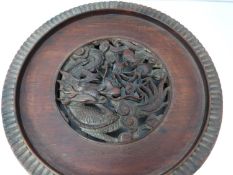 A Chinese 19th century hardwood pierced display stand, dragon motif with carved flower detailing