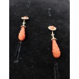 A pair of Victorian carved coral and gold plated drop earrings, coral drop engraved with geometric