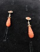 A pair of Victorian carved coral and gold plated drop earrings, coral drop engraved with geometric