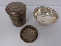 A collection of white metal dishes and a box decorated with coins and a silver and horn twist handle