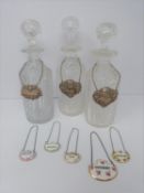 Three cut glass decanters with silver drinks labels and five ceramic drinks labels (Sherry,