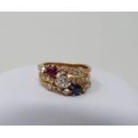 A Sapphire, Ruby and old mine diamond yellow metal jubilee ring, set to centre with a cushion shaped