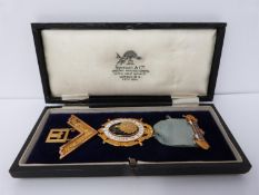A cased 9ct gold and enamel lodge kedah Masonic medal, hall marked 375, 9 ct, Spencer London,