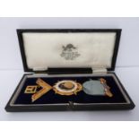 A cased 9ct gold and enamel lodge kedah Masonic medal, hall marked 375, 9 ct, Spencer London,