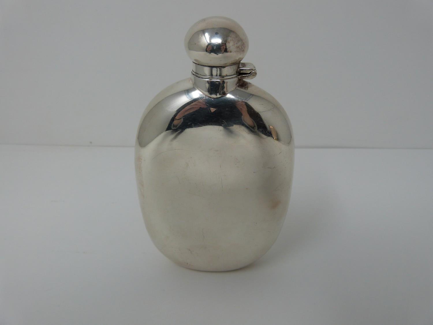 A Silver Harrods hip flask, Sheffield 1991, swilvel lock top. (171g).