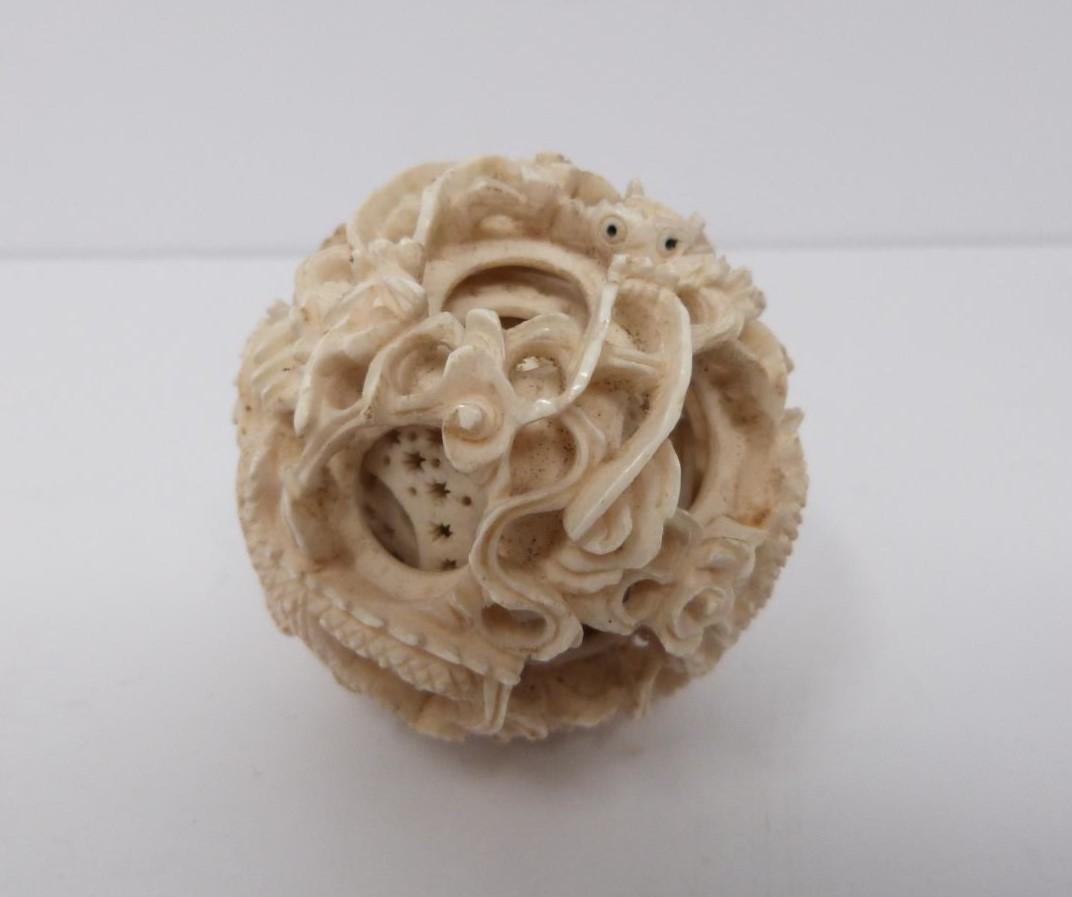An early 20th century ivory puzzle ball and a small carved ivory and white metal burner, dragon - Image 6 of 7