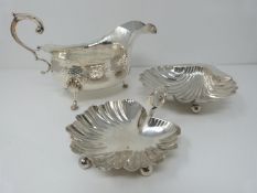 A silver sauce boat, Birmingham, Elkington and Co, 1908, a small handled shell dish, Sheffield,