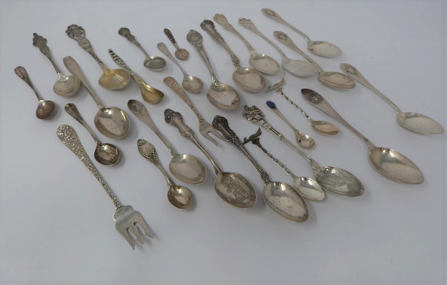 A collection of silver spoons, including tourist and collector's spoons. (411g).