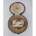 A 9ct stamped yellow gold landscape cameo brooch depicting man and woman climbing into a chariot